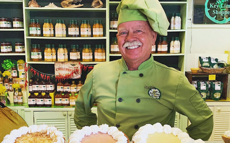chef with pies and shelves of wares at kermits key west lime shoppe