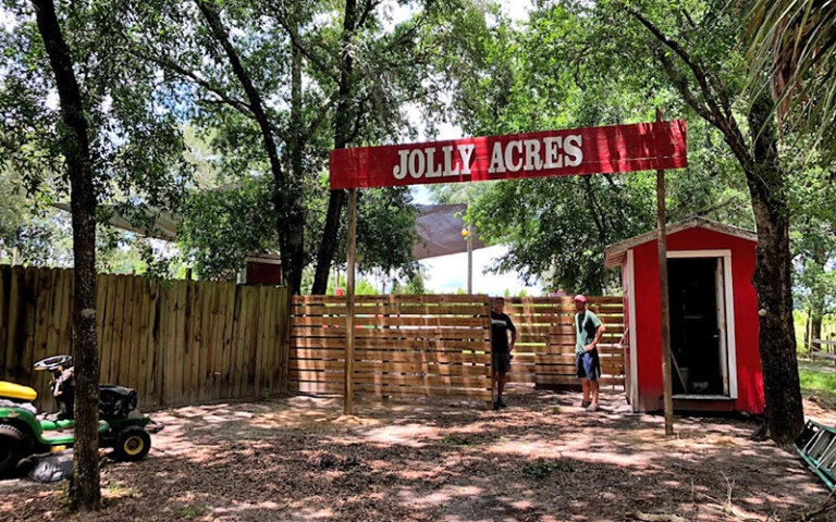 corral area with jolly acres sign and tractor at santas farm eustis