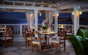 dining veranda overlooking ocean at night at hot tin roof key west