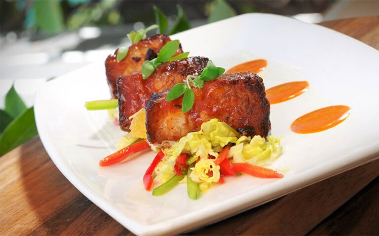 dish with three cuts of meat at hot tin roof key west