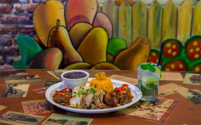 entree with mojito on table with cuban decor at el meson de pepe key west