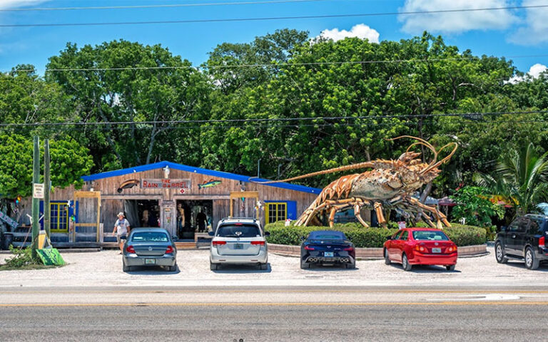 exterior from highway with giant lobster sculpture and cars at rain barrel village islamorada florida keys