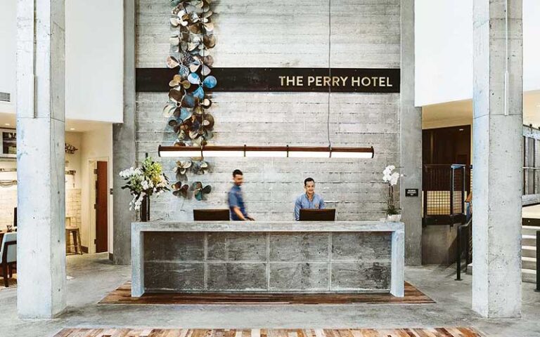 front desk with sign and propellers at the perry hotel marina key west