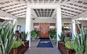 front door with blue rug and covered area plants at prime steakhouse key west