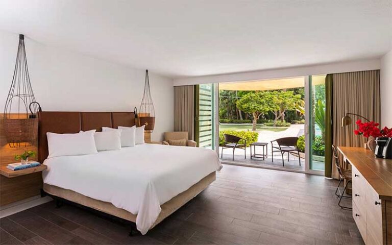 garden view king bed hotel room with wood decor at amara cay resort islamorada fl keys