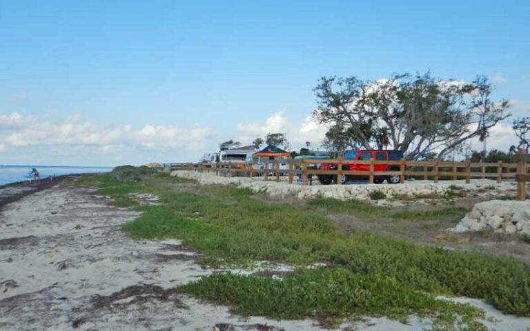 grassy beach area with parking behind fences at bahia honda state park florida keys