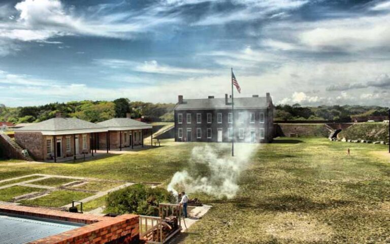 historic fort buildings with cannon smoke at fort clinch state park jacksonville
