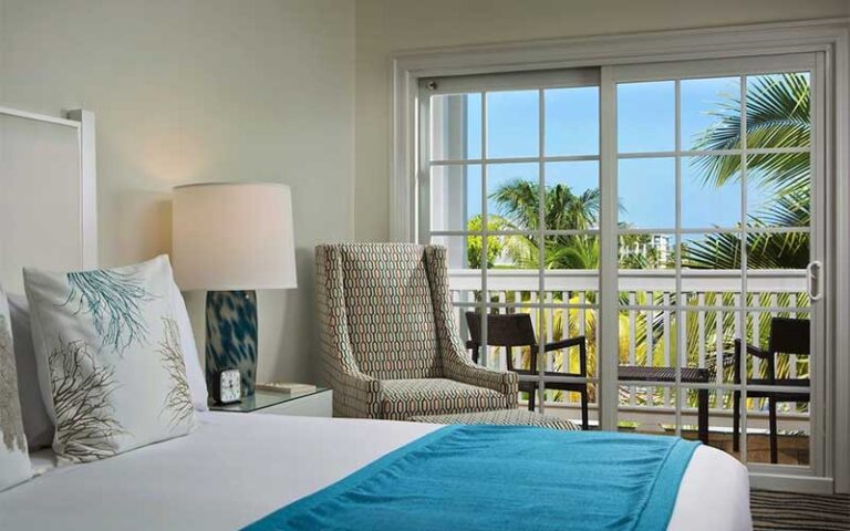 hotel room with chic decor and sliding door view at the marker key west harbor resort