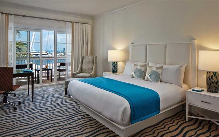 king size bed room with marina view at the marker key west harbor resort