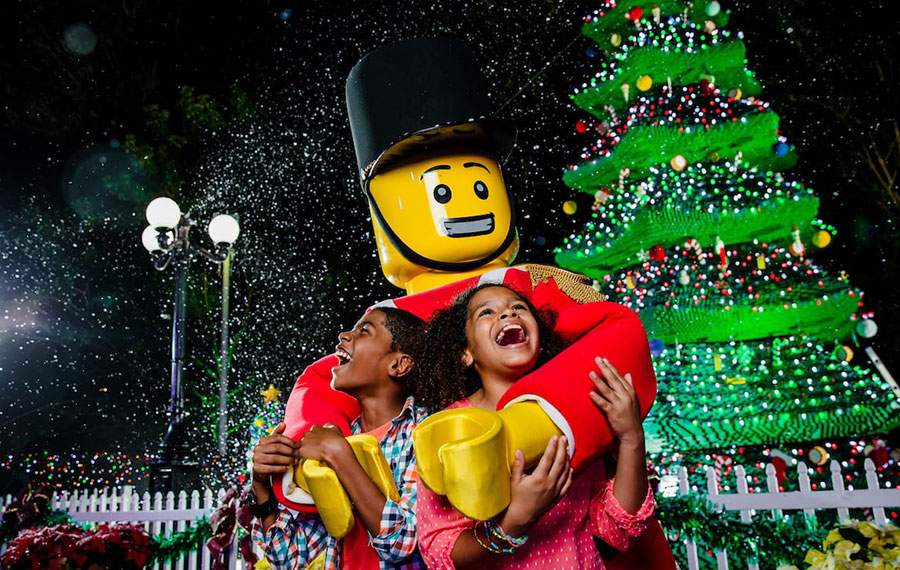 lego toy soldier character hugging kids with tree and snow at legoland florida