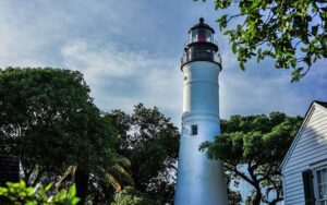 lighthouse and building with trees at key west lighthouse and keepers quarters museum