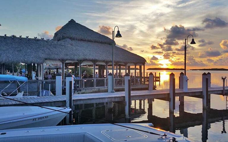 marina tiki hut dining area with gulf and sunset at islamorada fish company fl keys