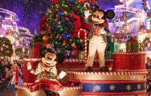 mickey and minnie on christmas parade float with snow at magic kingdom disney park