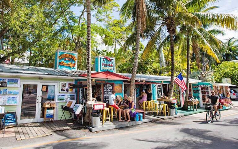 row of shops and restaurants with island theme at key west historic seaport