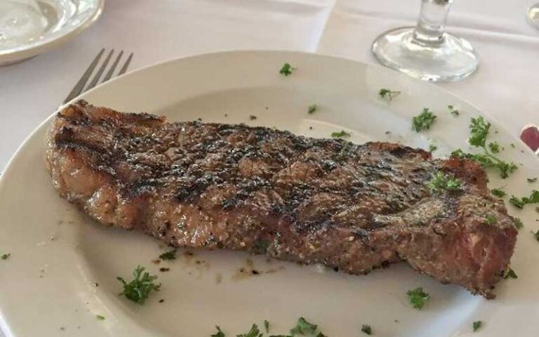 steak on plate with table setting at hideaway cafe marathon fl keys