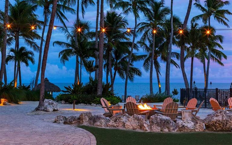 twilight on beach with fire and lights at amara cay resort islamorada fl keys