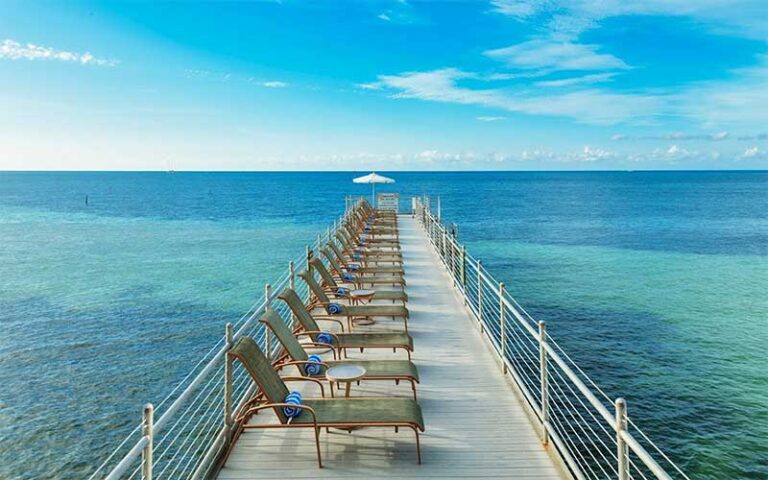 view along dock with chairs and clear ocean and sky at southernmost beach resort key west