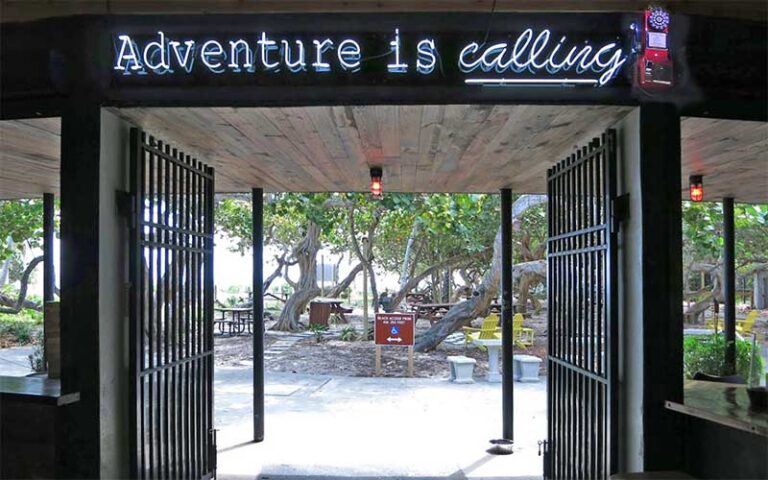 view out doorway with sign adventure is calling at park and ocean ft lauderdale