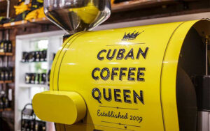 yellow coffee roaster with logo and coffee shop background at cuban coffee queen downtown key west
