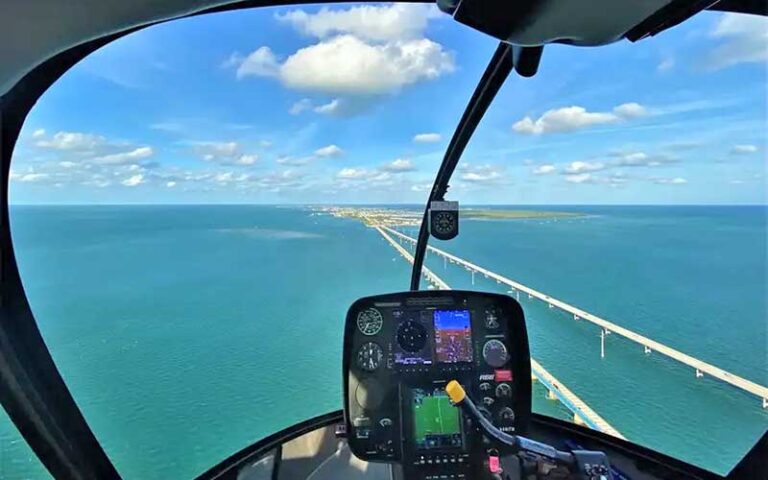 aerial view of seven mile bridge framed in cockpit at keys helicopter tours marathon