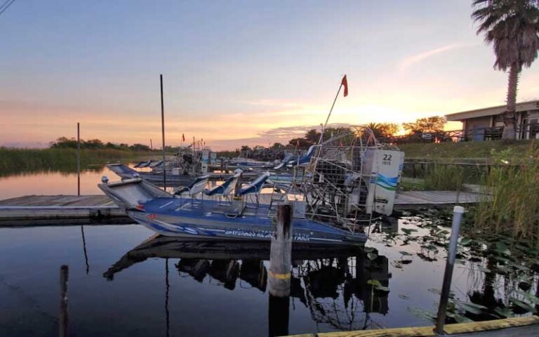 airboat at dock with sunset over marsh at sawgrass recreation park everglades