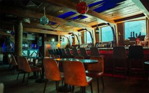 bar area with seating and aquarium windows at the wreck bar fort lauderdale