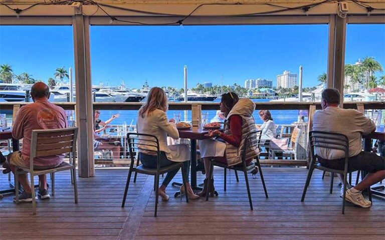 diners seated on veranda overlooking marina at coconuts fort lauderdale
