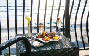 dining setting with fruit breakfast on balcony over beach at azurea at one ocean jacksonville