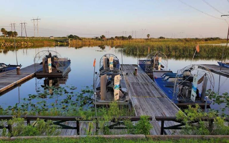 dock on marsh with several airboats at sawgrass recreation park everglades