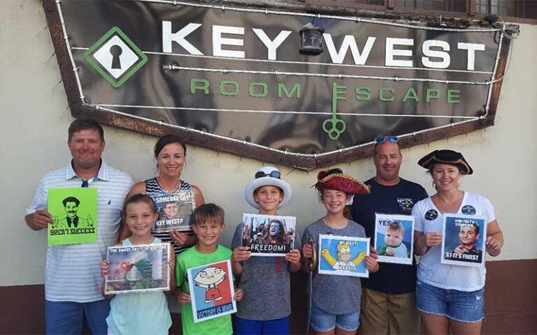 family posing under outdoor sign at key west room escape