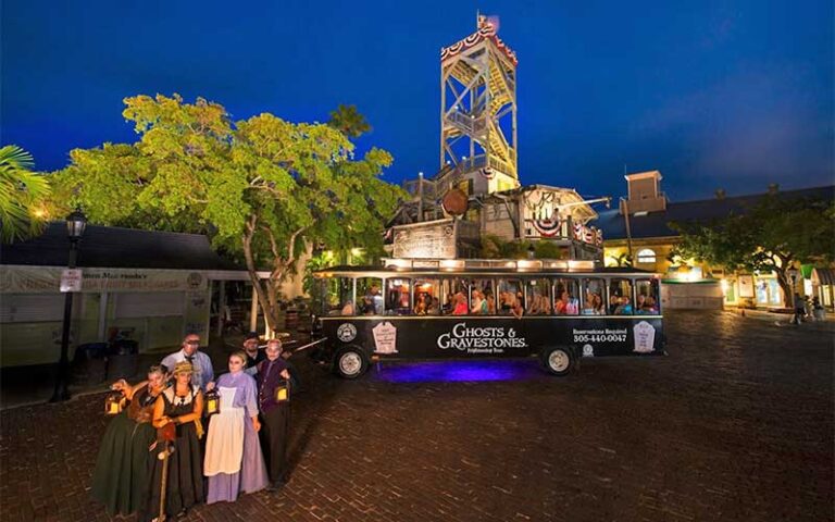 group of ghost characters with trolley bus outside shipwreck museum at ghosts and gravestones tour key west