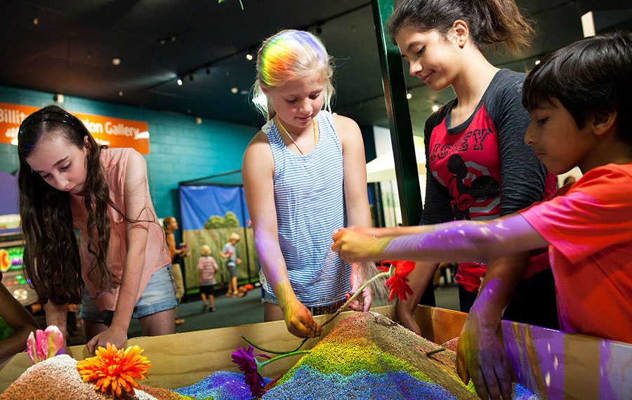 kids playing in hands on soil exhibit with colorful lighting mosh museum of science history jacksonville