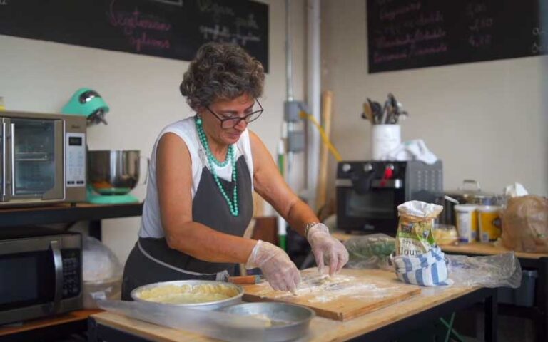 lady baker rolling dough in kitchen area at yellow green farmers market hollywood fl