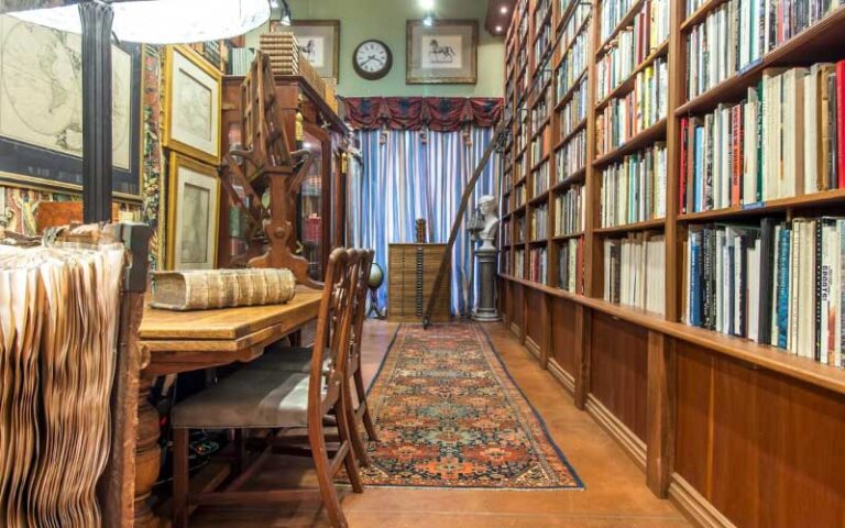 maps and charts with book shelves and statue at old florida book shop fort lauderdale