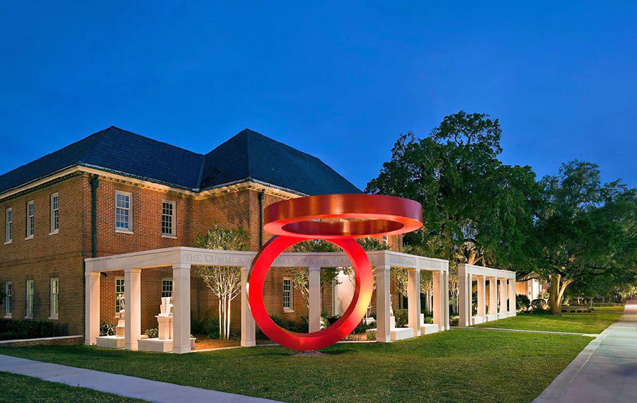 night exterior of lit up building with red rings sculpture cummer museum art gardens