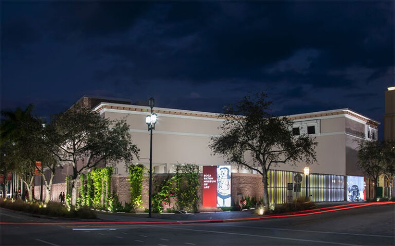 night exterior of museum with exhibit banner at boca raton museum of art