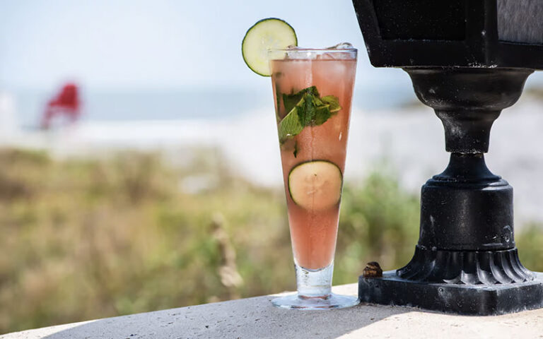 pink cocktail glass on balcony wall overlooking ocean at azurea at one ocean jacksonville