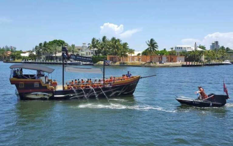 pirate style ship with smaller boat facing off in inlet at bluefoot pirate adventures fort lauderdale