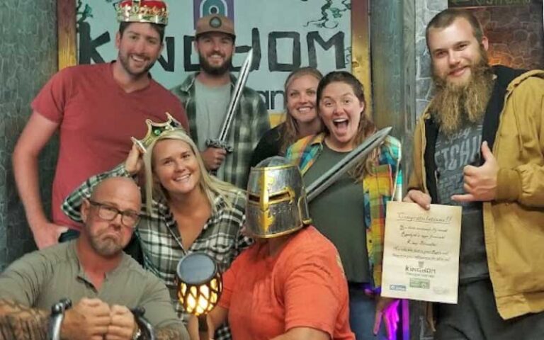 posing group with props after game at kingdom escape games key largo