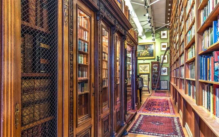 rare books in glass cases and paintings at old florida book shop fort lauderdale