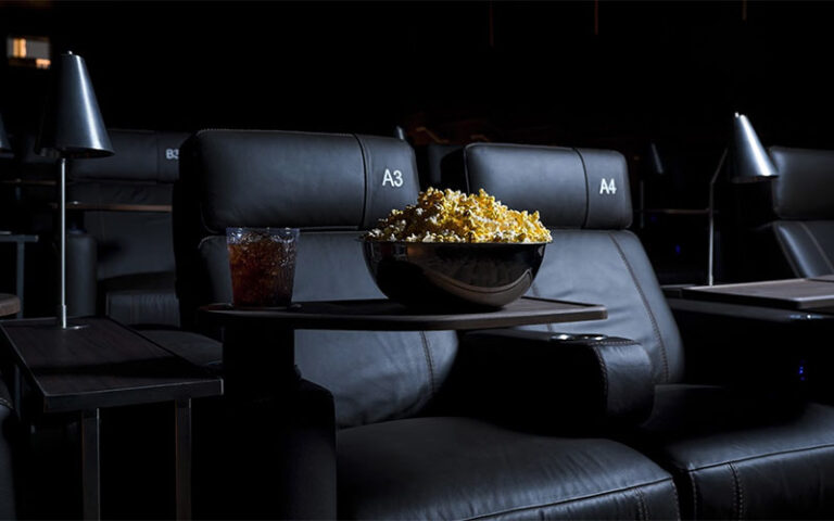 reclining luxury theater seats with table and lamp with popcorn and drinks at cinepolis coconut grove miami