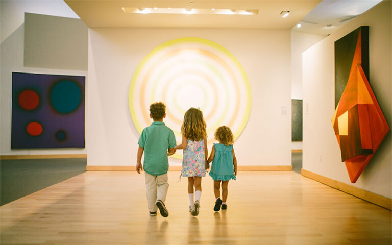three kids looking at art in exhibit space at boca raton museum of art
