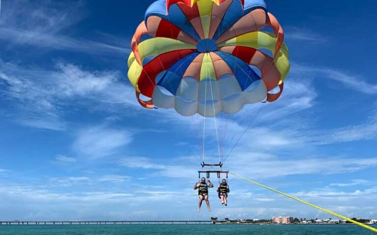 two parasail riders with rainbow chute at z flight parasail watersports marathon fl keys