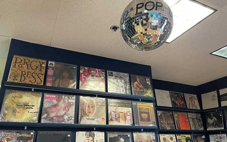 wall mounted records and disco ball at radio active records fort lauderdale