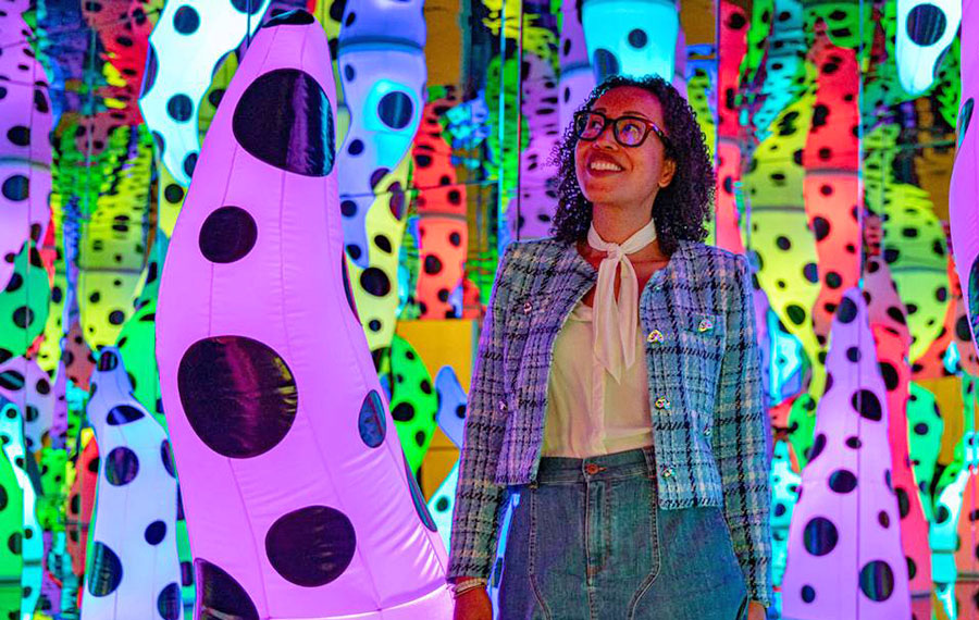 woman walking through colorful art exhibit perez museum art miami