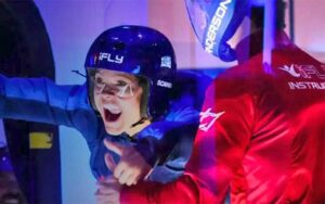 young person with trainer in helmets in wind tunnel at ifly fort lauderdale