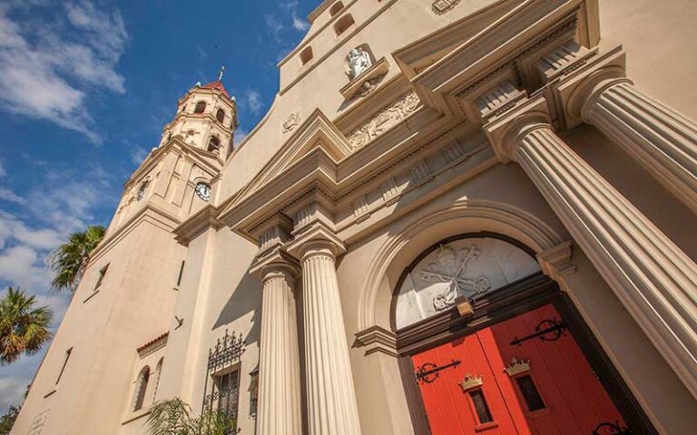 angled view up with red door and tower at cathedral basilica of st augustine