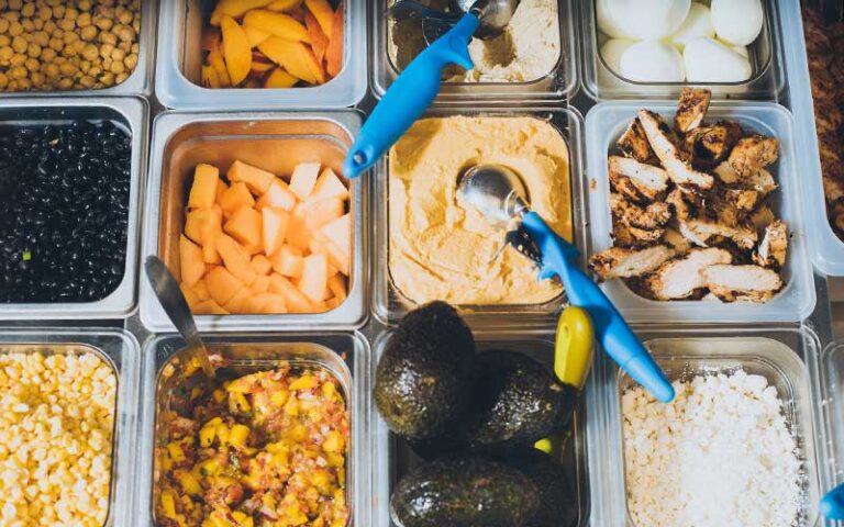 array of healthy toppings with avocado and hummus at crave st augustine