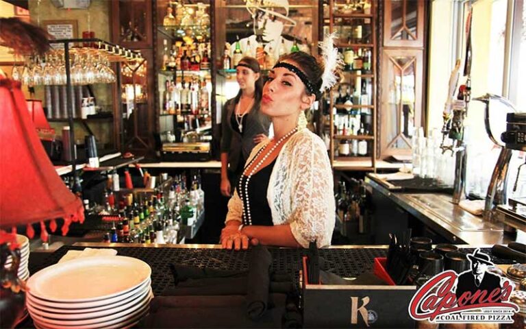 bar staff dressed in jazz age costume behind counter at capones coal fire pizza fort myers