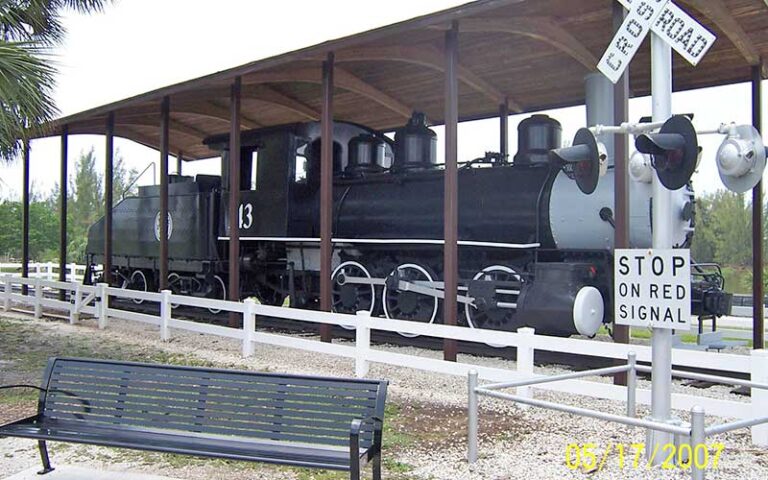 black locomotive with coal car on display under shelter outside at railroad museum of south florida fort myers